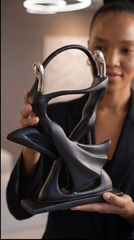 Stylized resin human figure sculpture in matte black with simplified silhouette