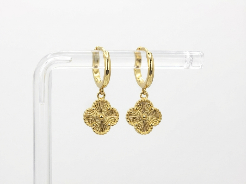 Woman wearing clover gold hoop earrings - waterproof stainless steel jewellery South Africa