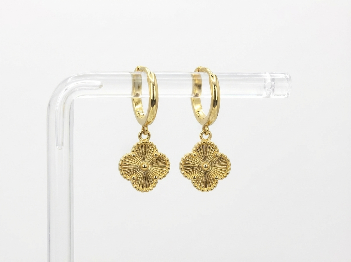 Woman wearing clover gold hoop earrings - waterproof stainless steel jewellery South Africa